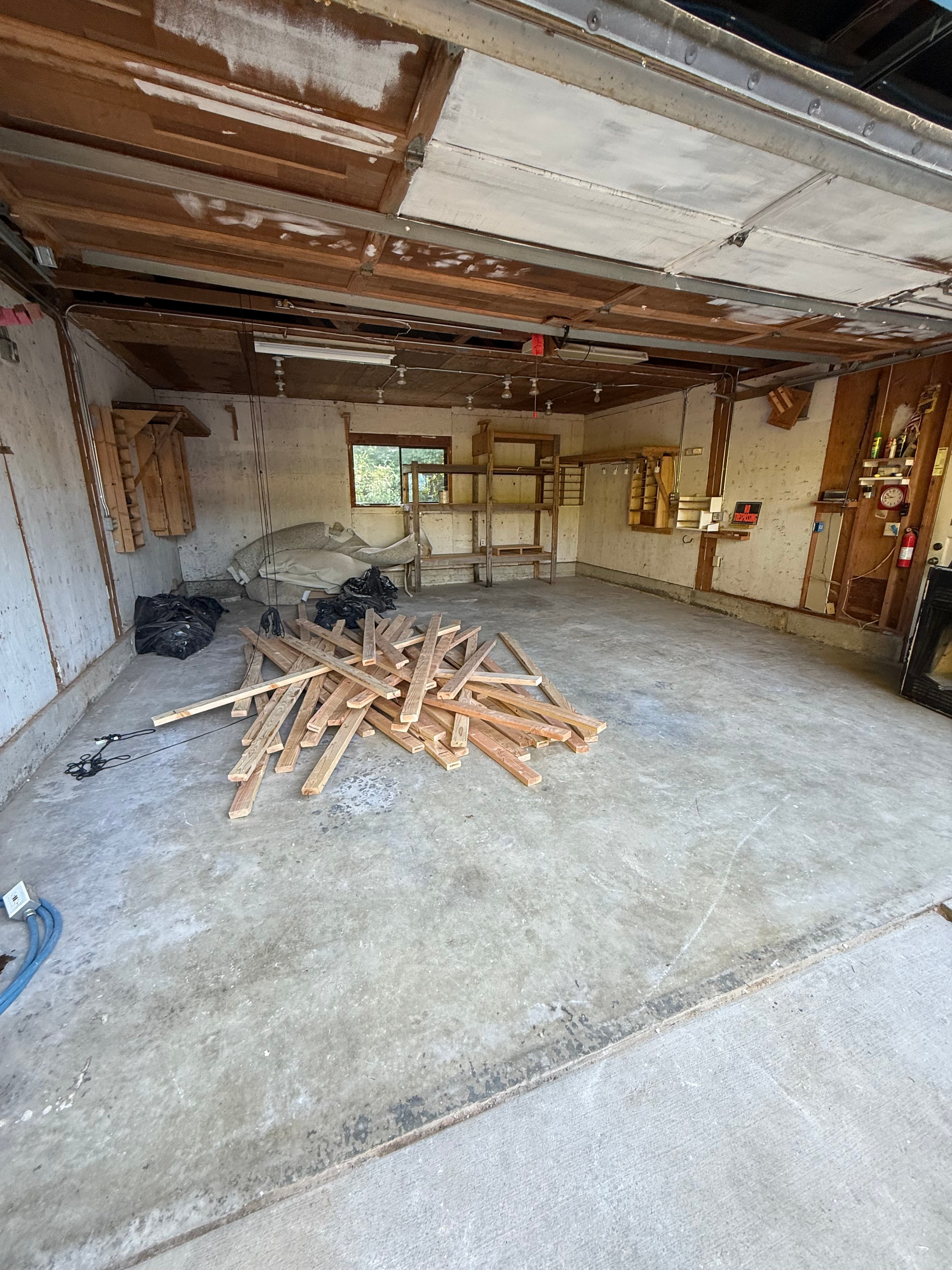 Garage cleaned out after debris removal with floor space restored